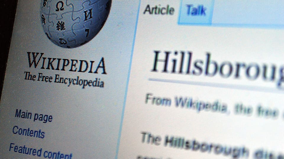 Close-up of the Wikipedia globe logo on the English Wikipedia site, shown on a computer screen