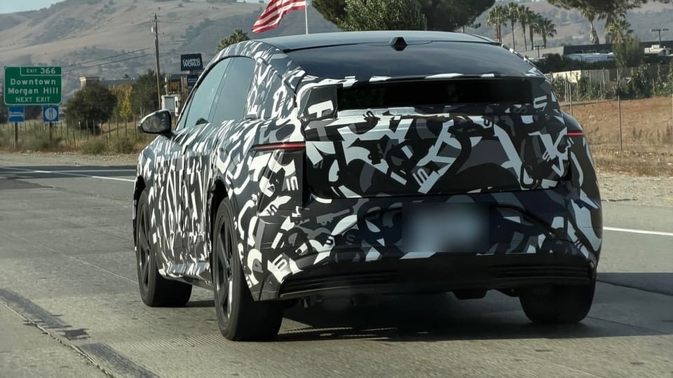 A camouflaged Lucid Cosmos prototype driving on Highway 101 in California