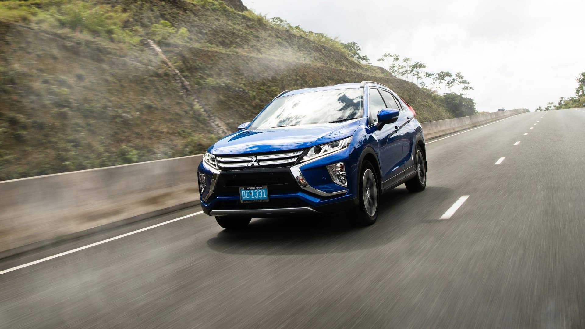 Blue Mitsubishi Eclipse Cross driving on a road