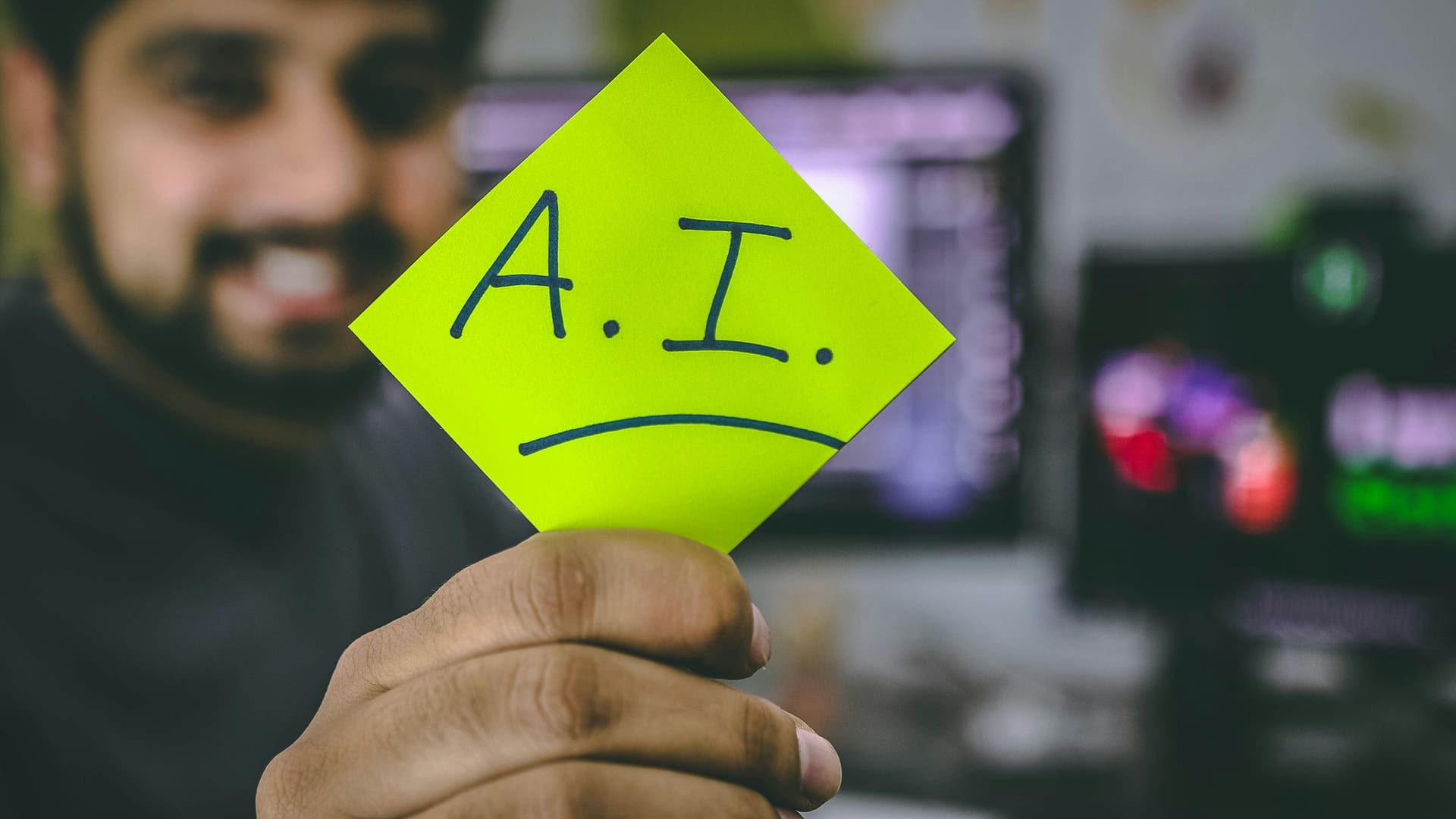 Person holding green paper with artificial intelligence text