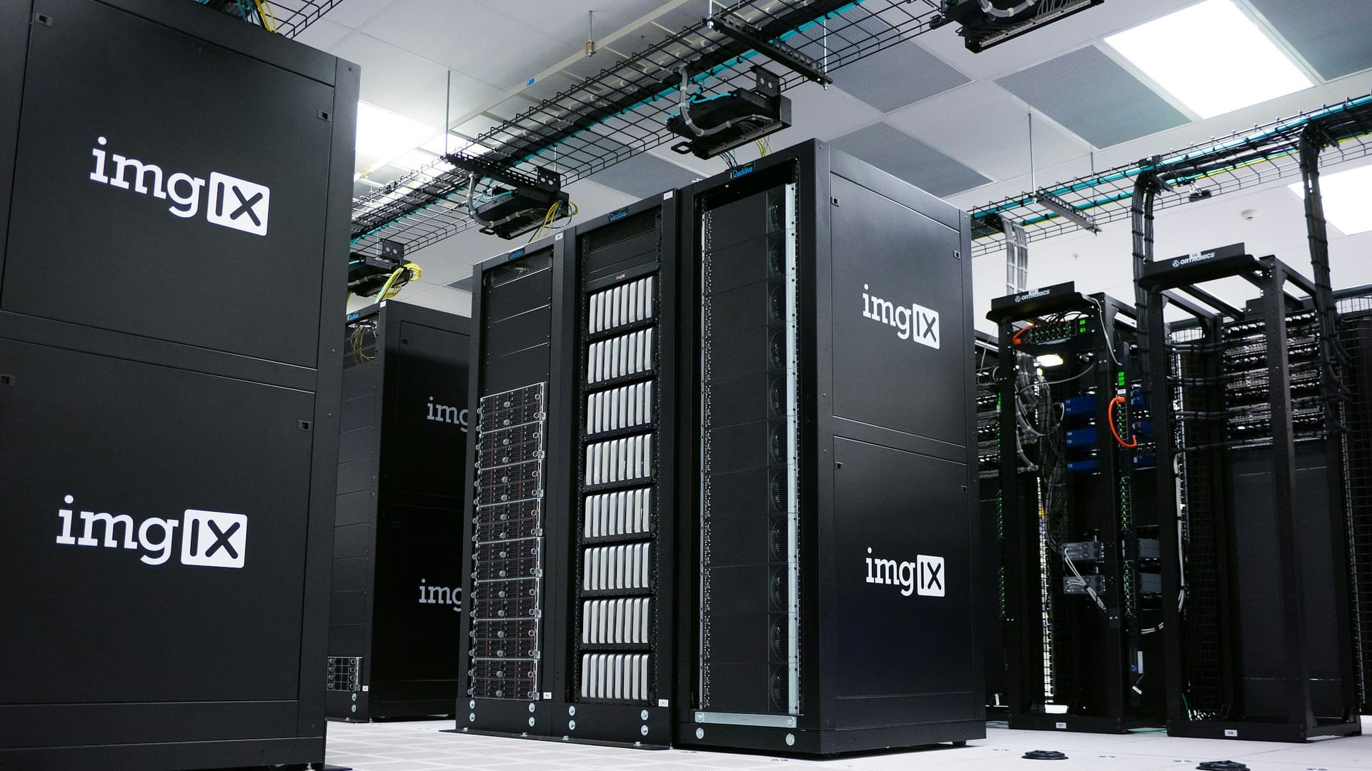 Rows of black server racks arranged in a data center facility