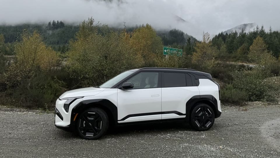 Kia EV3 compact electric SUV driving on the road during a first drive review