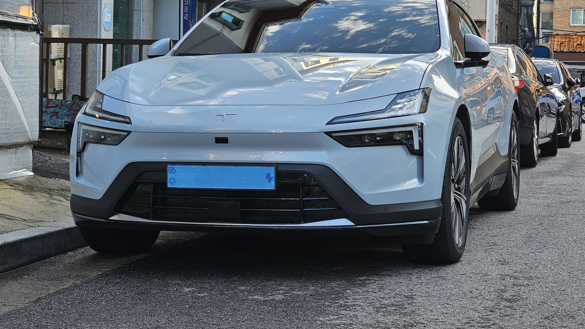 Polestar 4 SUV rear view in magnesium color, showing rear window design