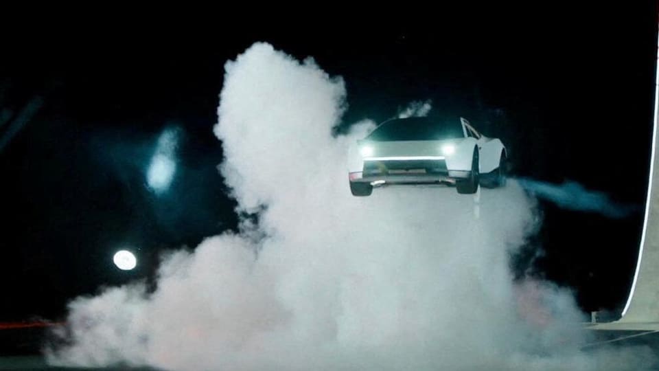 White Tesla Roadster airborne, demonstrating SpaceX thruster technology