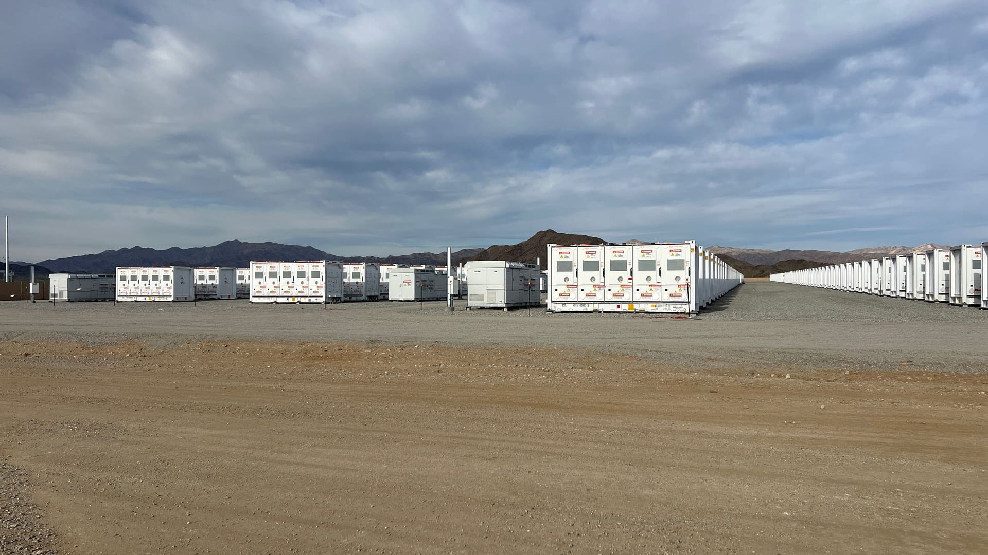 Rows of battery storage units at the Sunlight Storage II energy storage facility in the Riverside County, California desert