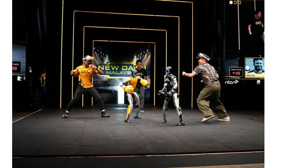 Humanoid robots compete at New Dawn MY with human pilots Safee Sali and Koo Kien Keat.