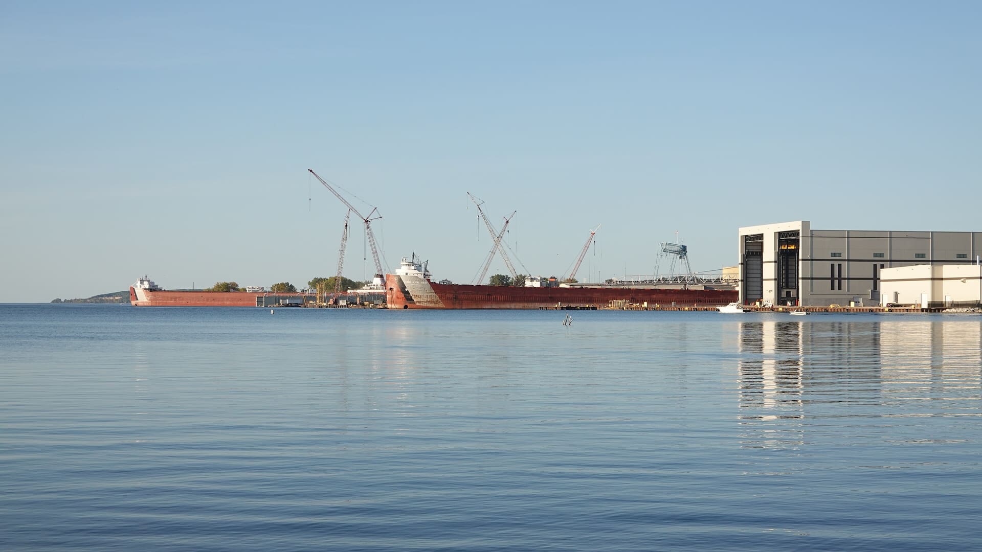 Fincantieri shipyard in Sturgeon Bay with industrial equipment and docked vessel