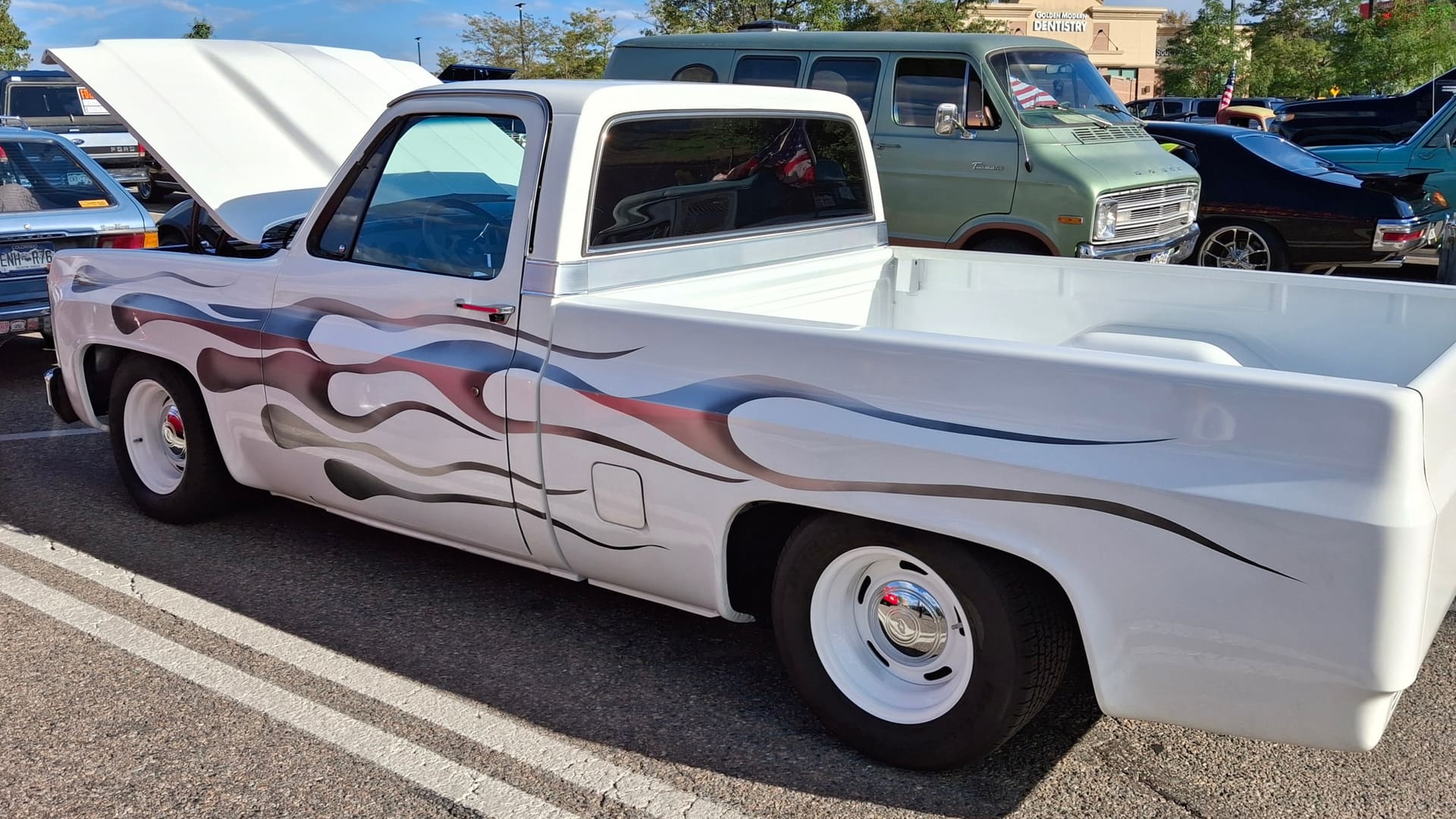 White GM pickup truck with custom flame paint at Super Cruise event