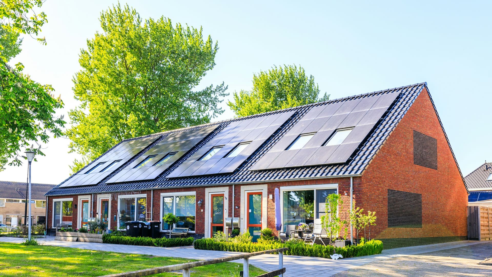Residential house with multiple solar panels installed on the rooftop