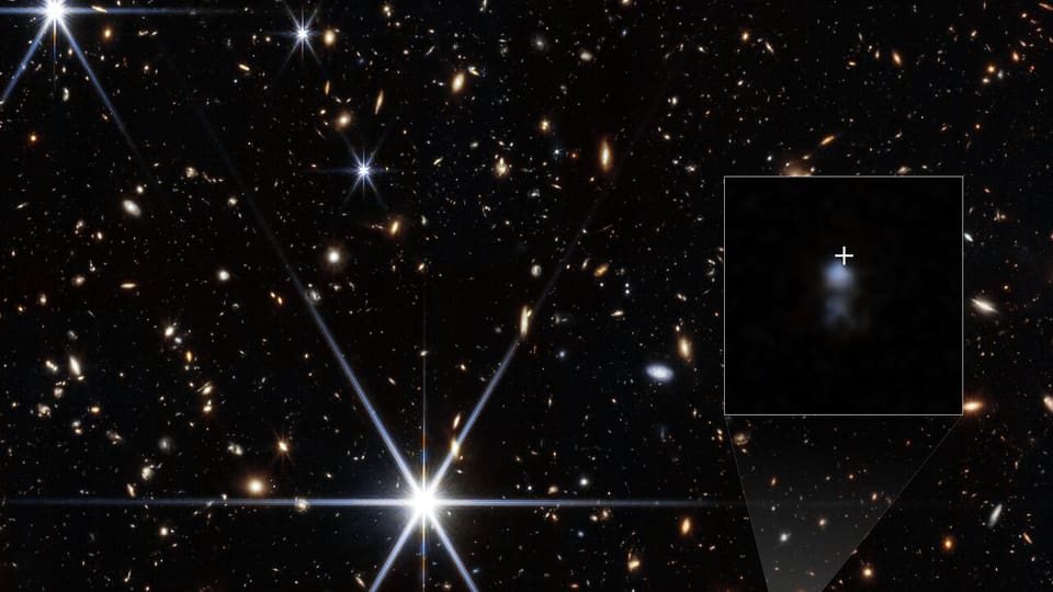 Webb image of the young host galaxy of the farthest known fast radio burst, with the burst’s location marked.