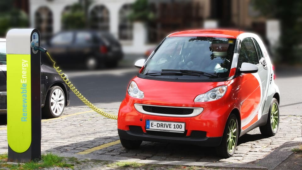 Electric car plugged into a street charging station in Berlin, Germany