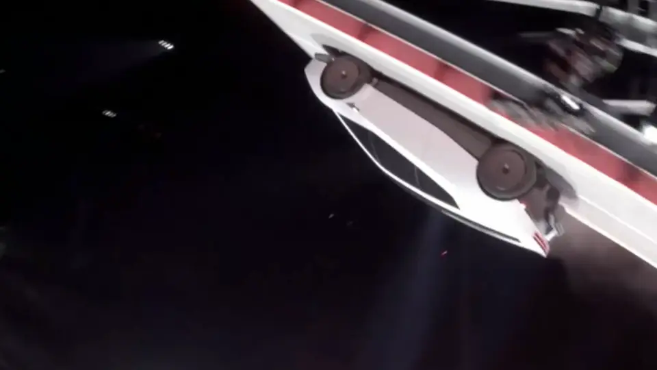 The Roadster driving upside down along the underside of a ramp at night