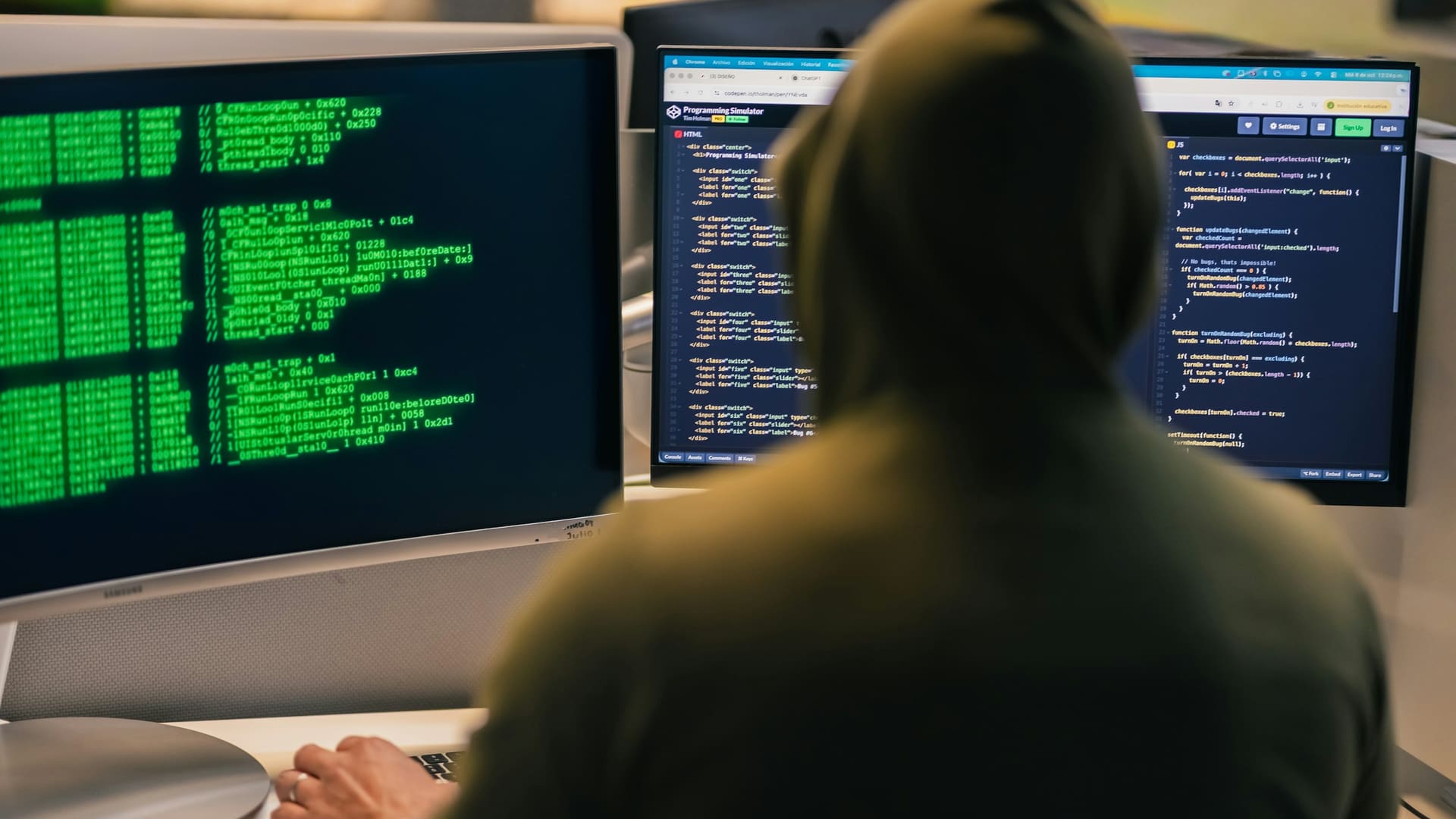 Security analyst working intently at multiple computer screens